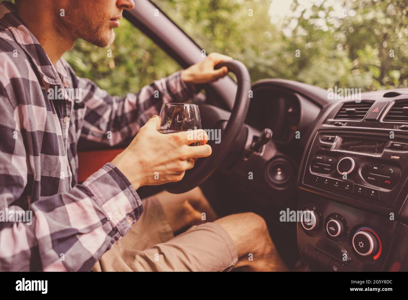 young crazy drunk man driving the car and drinking alcohol Stock Photo ...