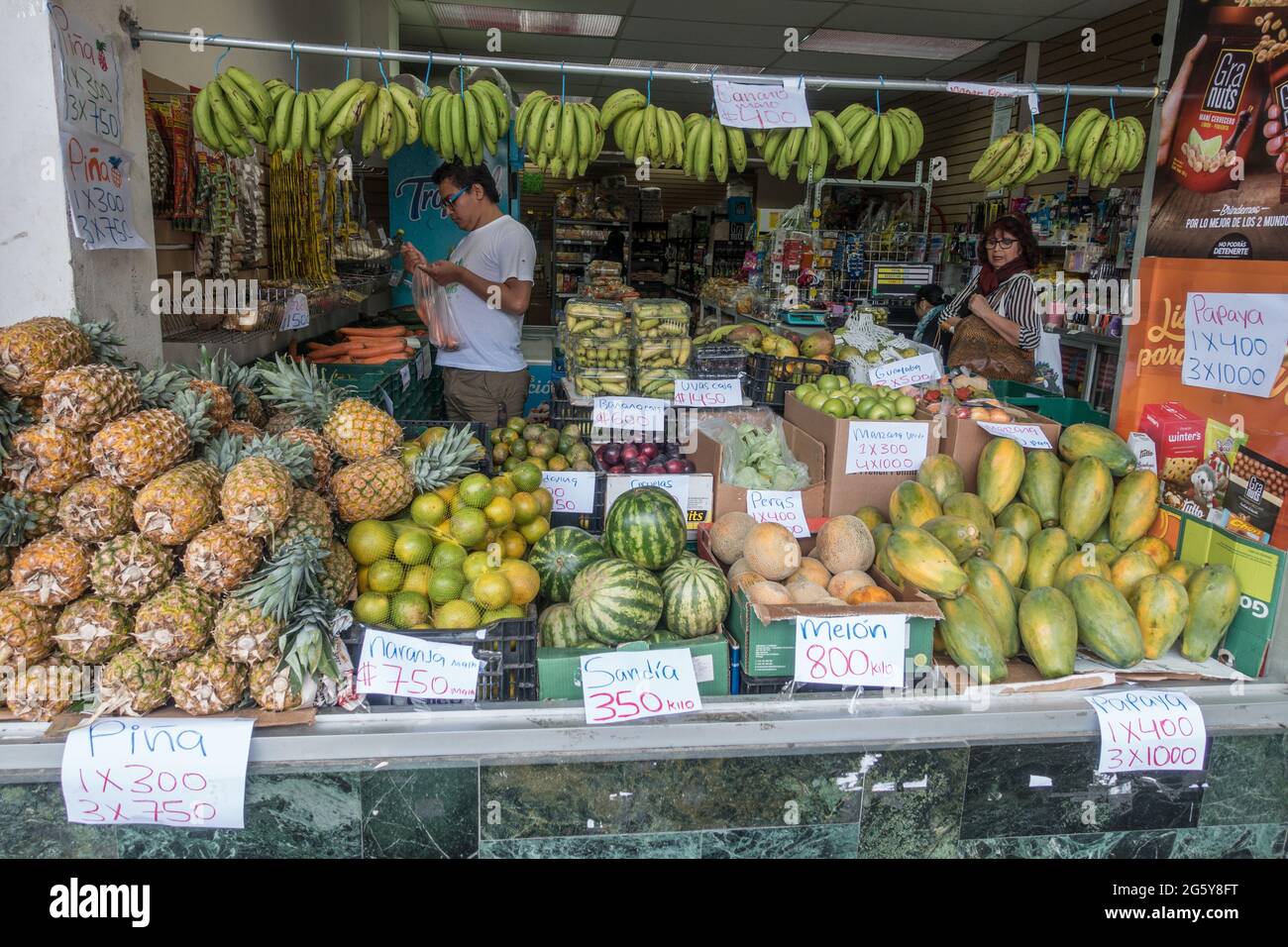 Man and woman shopping in a fruit market in San Jose, Costa Rica. Stock Photo
