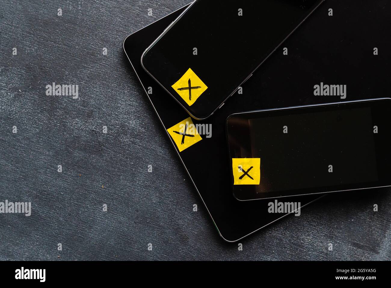 taped webcam cameras on smartphones and tablet, anonymous person concept, protect personal data Stock Photo