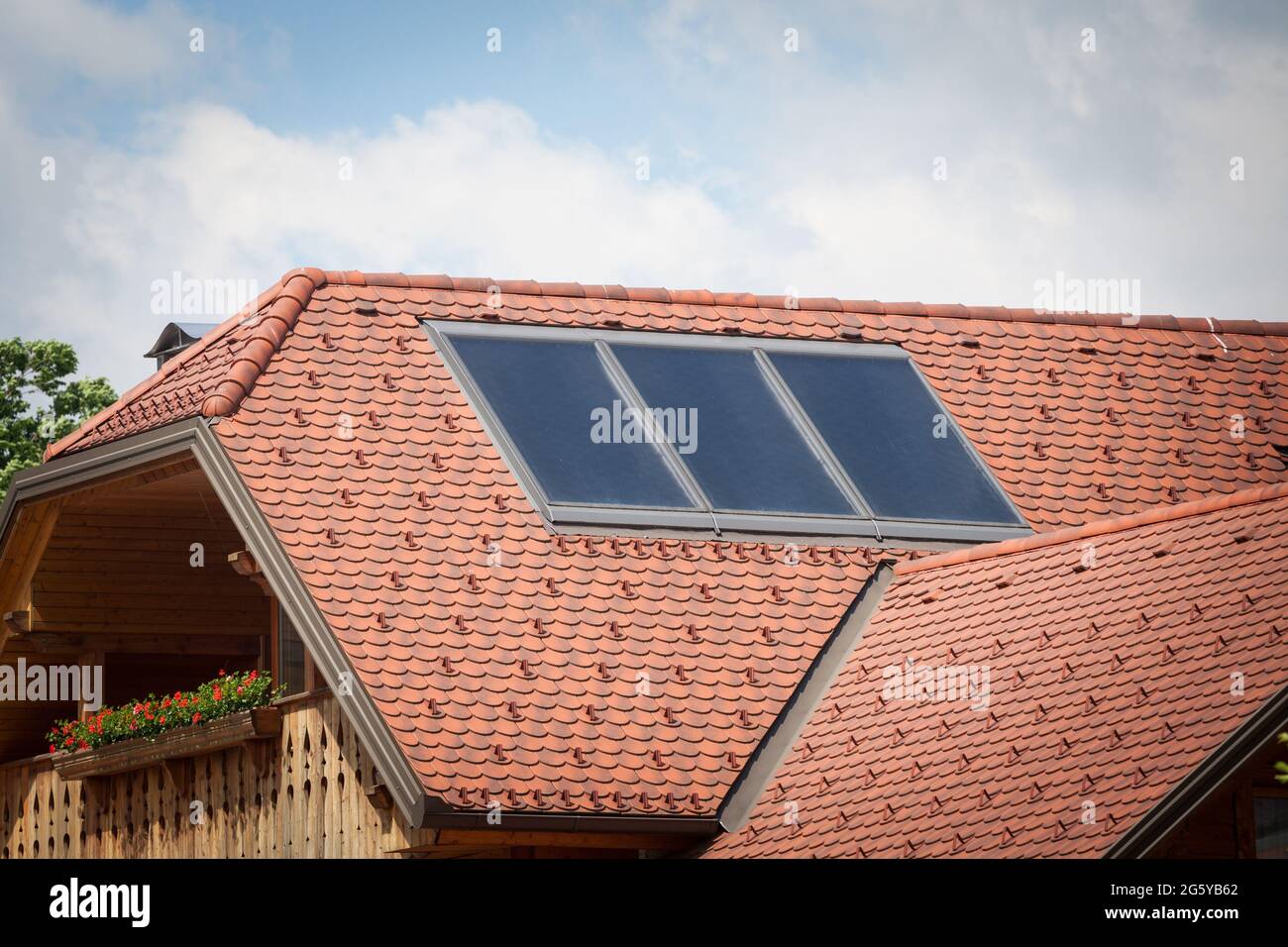 Picture of a solar panel on a roof of a chalet building in Slovenia.The term solar panel is used colloquially for a photo-voltaic (PV) module. A PV mo Stock Photo