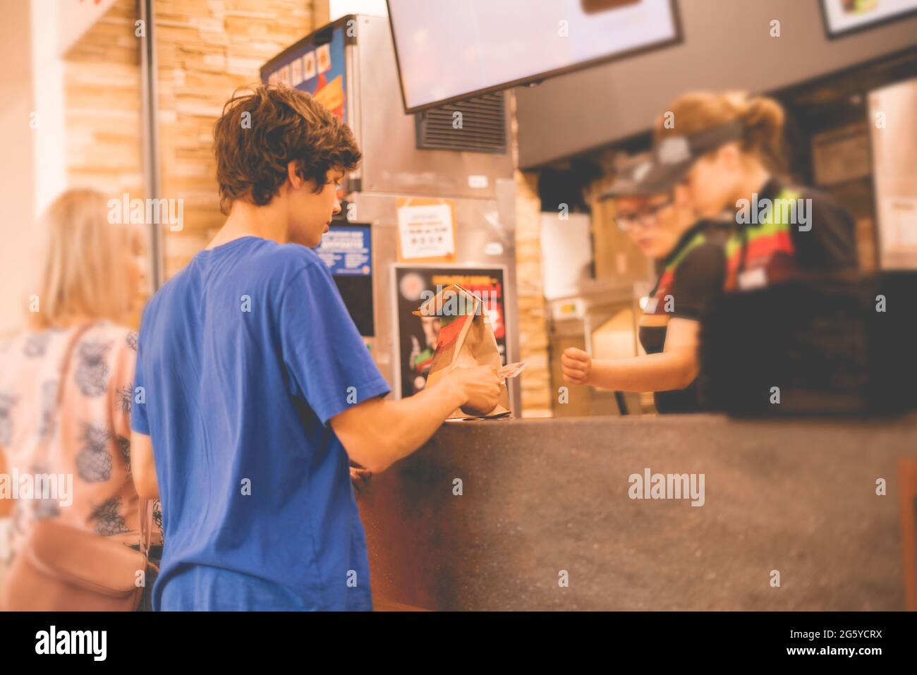 young man received his food package order in fastfood restaurant Stock ...
