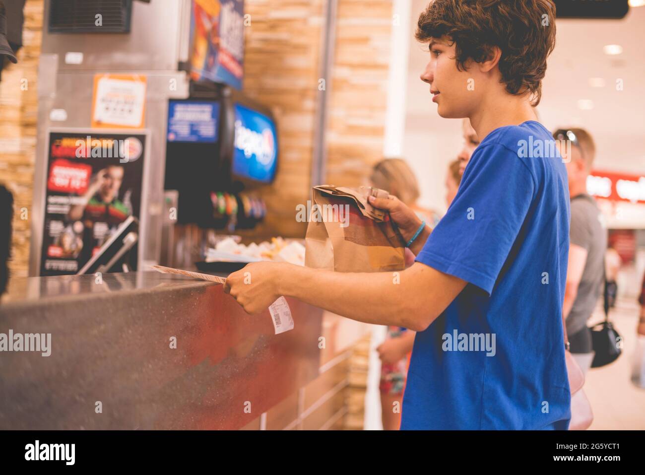young man received his food package order in fastfood restaurant Stock ...