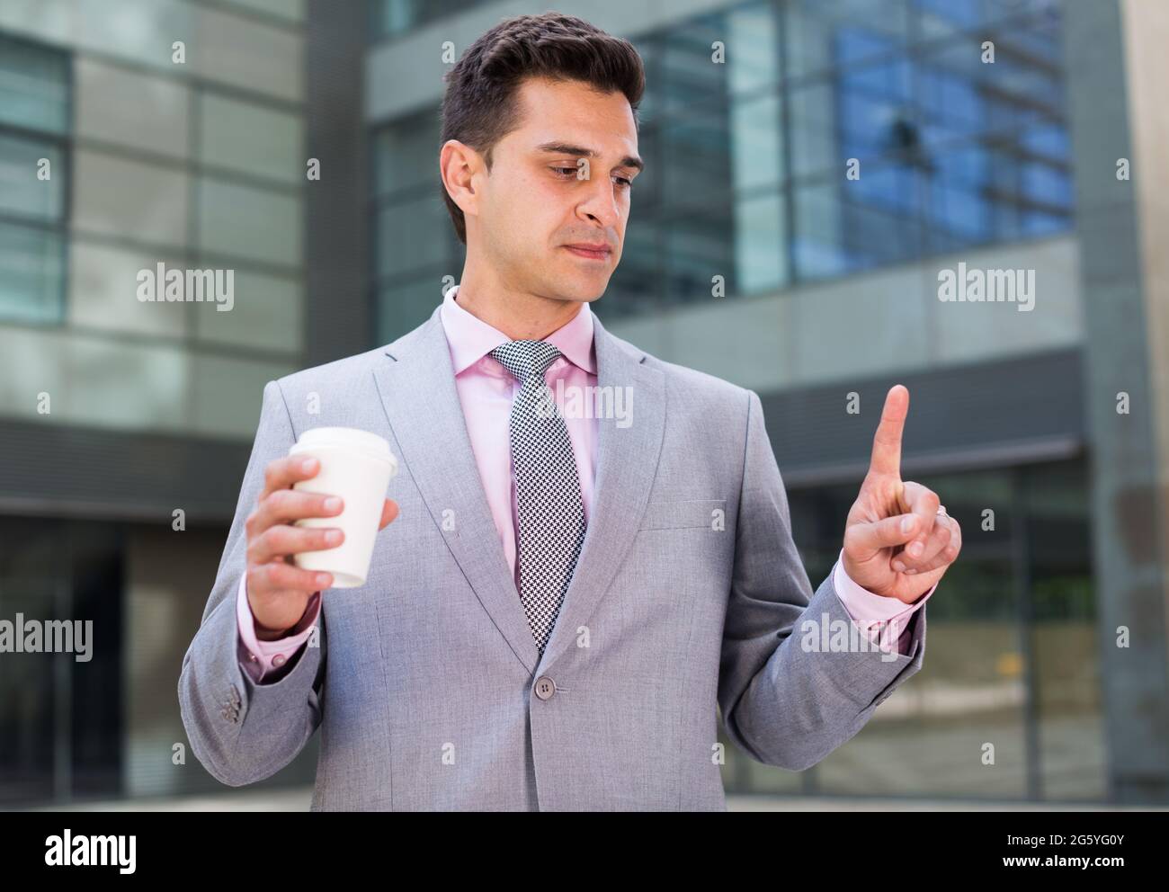 Businessman touching imaginary screen Stock Photo