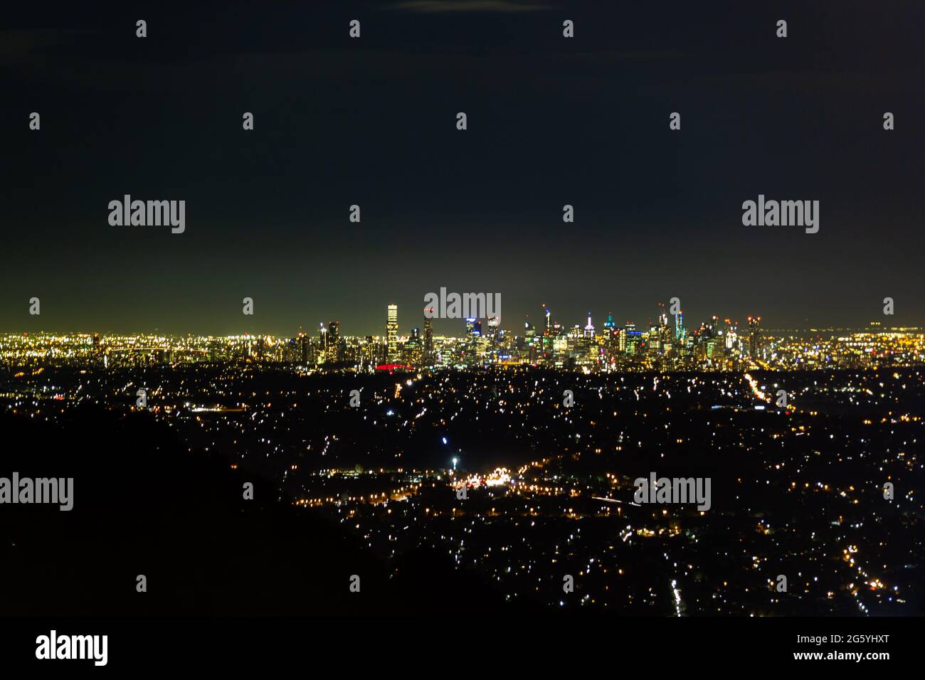 Aerial shot of glowing lights of Melbourne City and suburban sprawl at