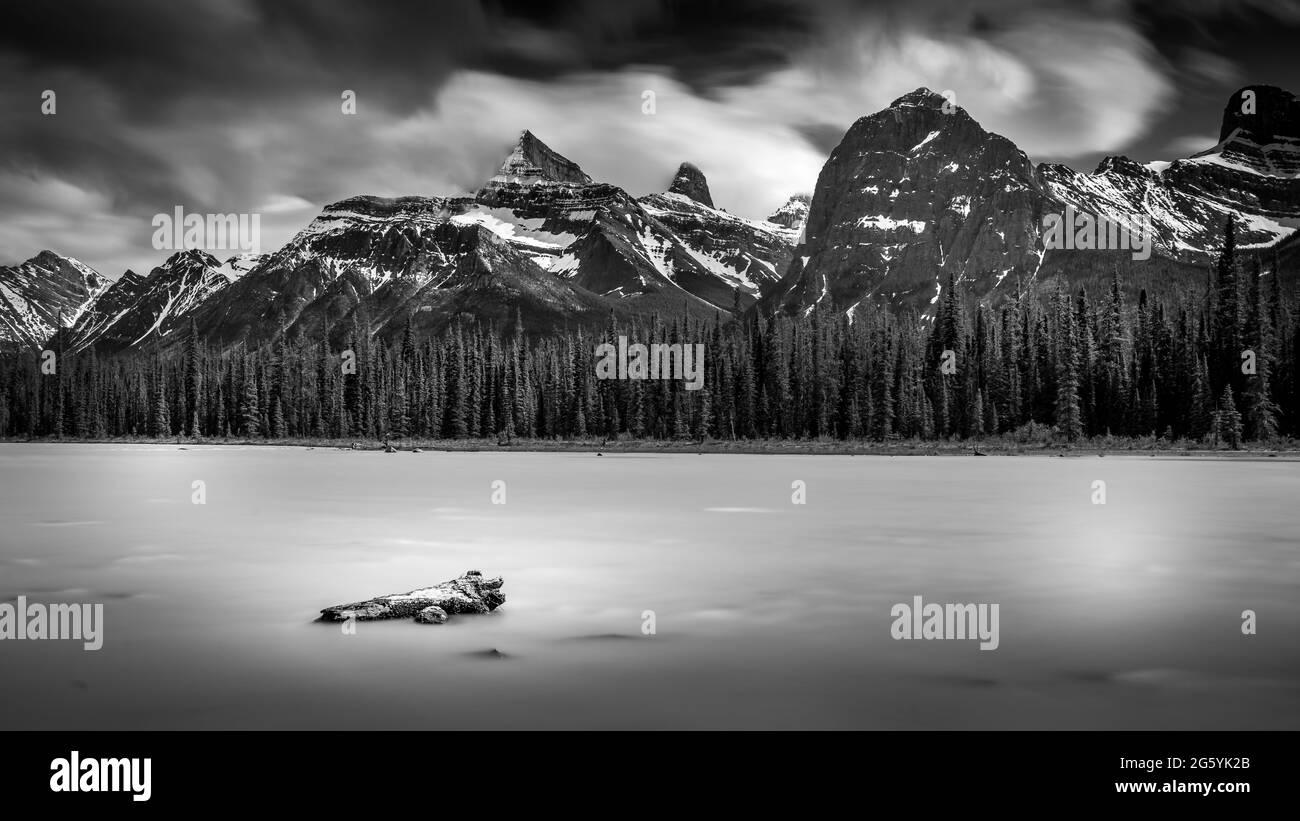 Black and White Long Exposure Photo of the Athabasca River with a piece of Driftwood in Jasper National Park along the Icefields Parkway Stock Photo