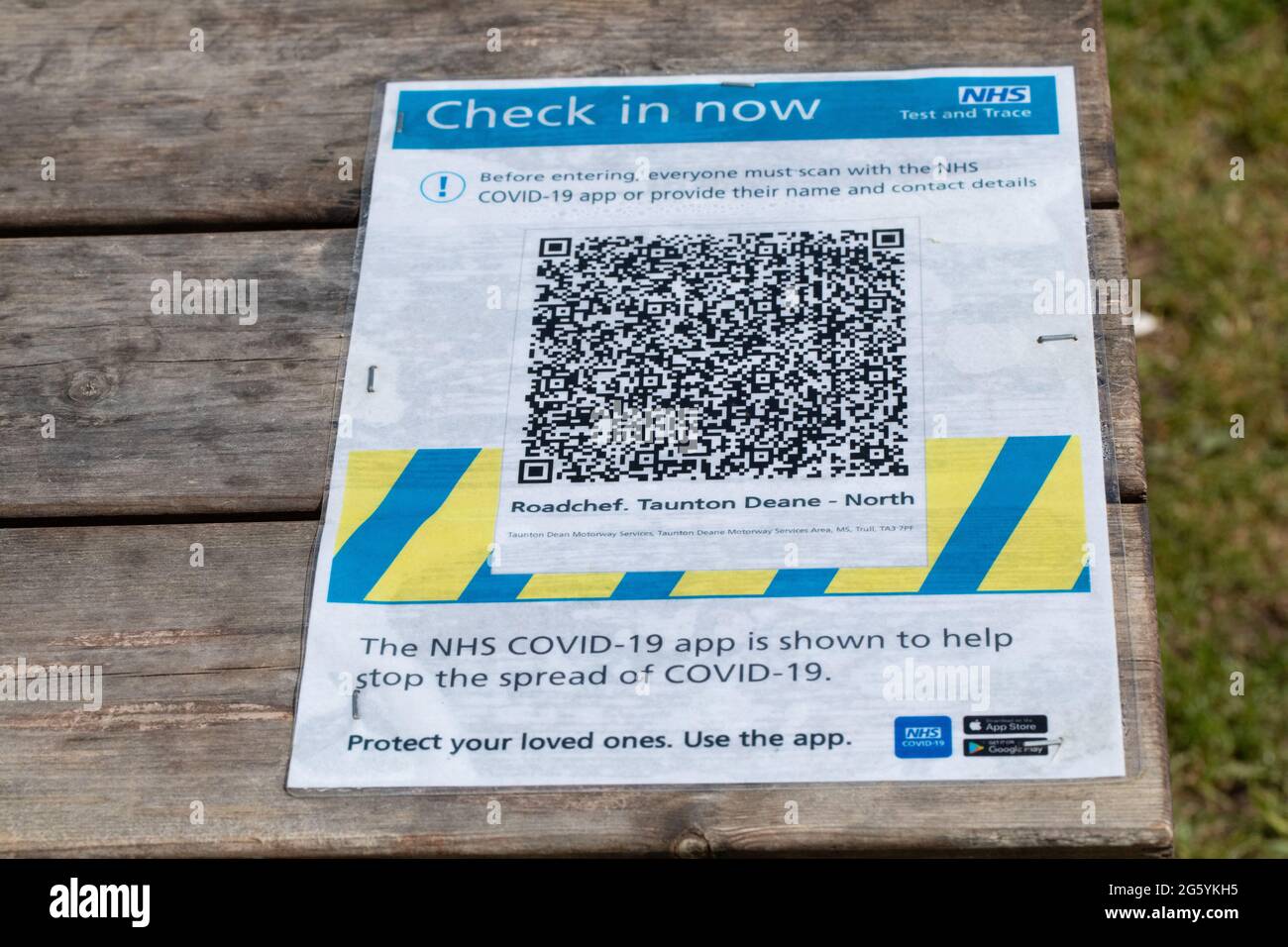 Motorway Service Station. NHS Covid 19 Test and Trace sign on a picnic table surface, requesting QR Code, contact details of customers, clients. June Stock Photo