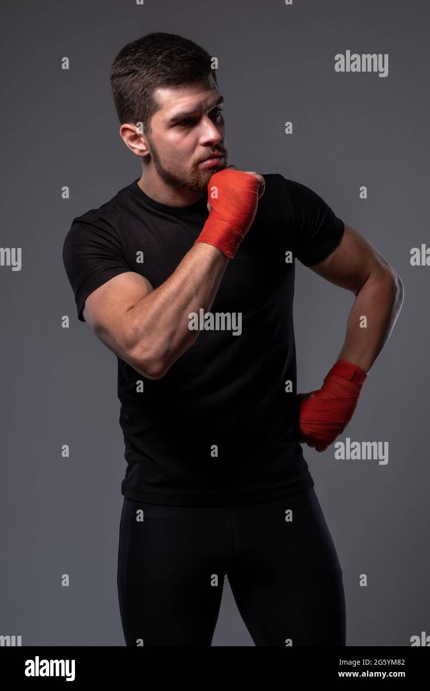 Pensive athletic man with boxing wrist wraps on grey background Stock Photo Alamy