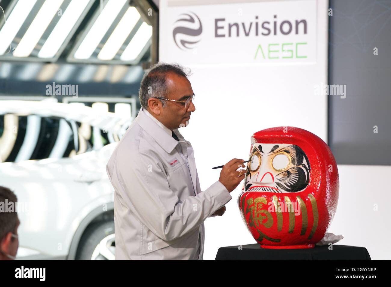 Nissan's Chief Operating Officer Ashwani Gupta puts the finishing touches to a Daruma - a hollow, round, Japanese traditional doll regarded as a talisman of good luck - after announcing that the Japanese car giant is to build a new electric model and huge battery plant in the UK in a massive boost to the automotive industry. Picture date: Thursday July 1, 2021. More than 1,600 jobs will be created in Sunderland and an estimated 4,500 in supply companies under an investment of £1 billion. Stock Photo