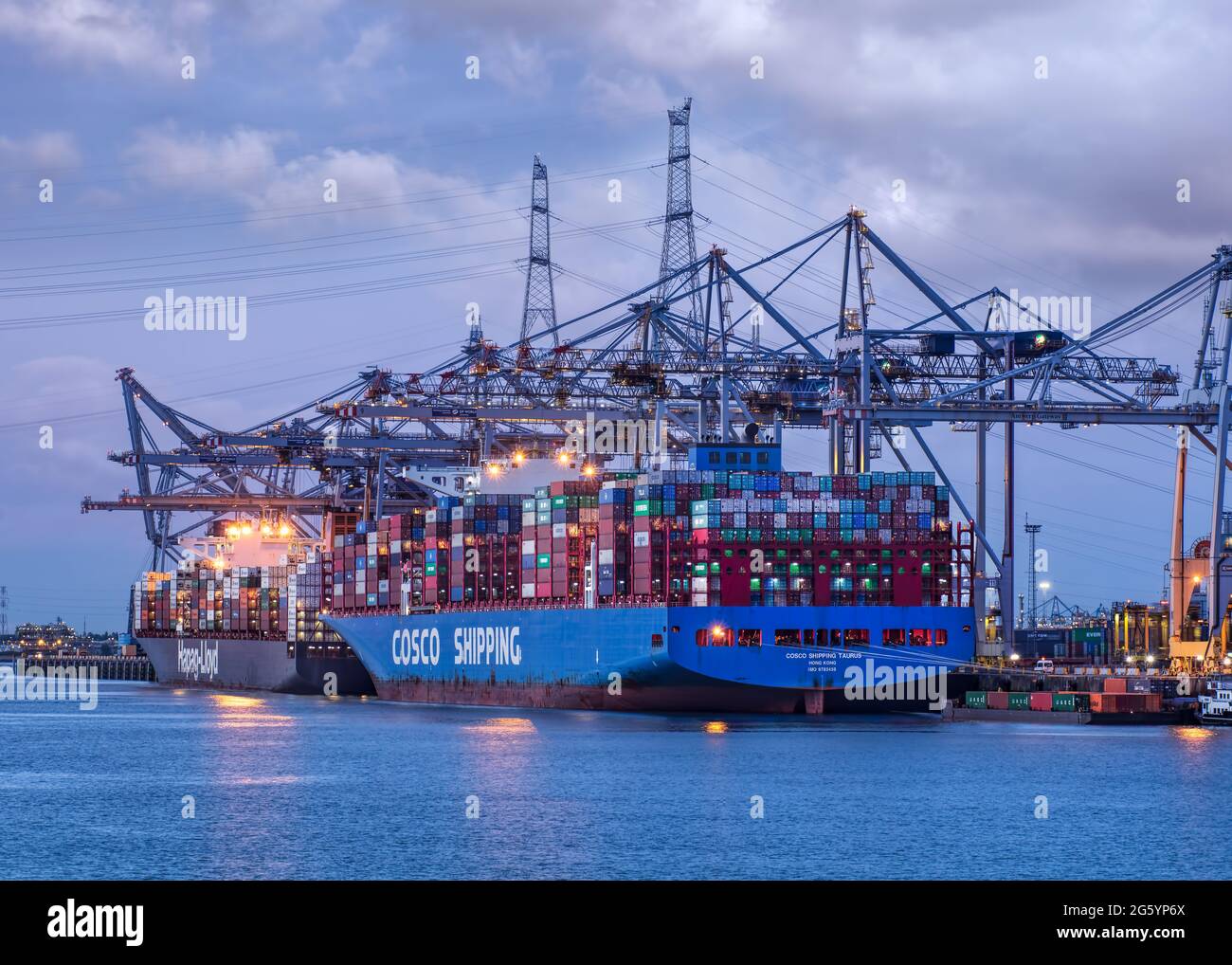 ANTWERP-MAY 28, 2021. Large container terminal with moored vessels at twilight. The Port of Antwerp in Flanders, Belgium is the second-largest seaport Stock Photo