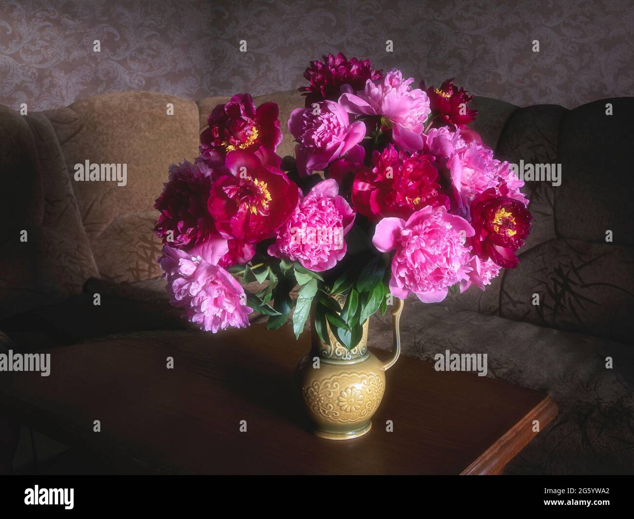 A bouquet of peonies in the interior of the living room Stock Photo - Alamy