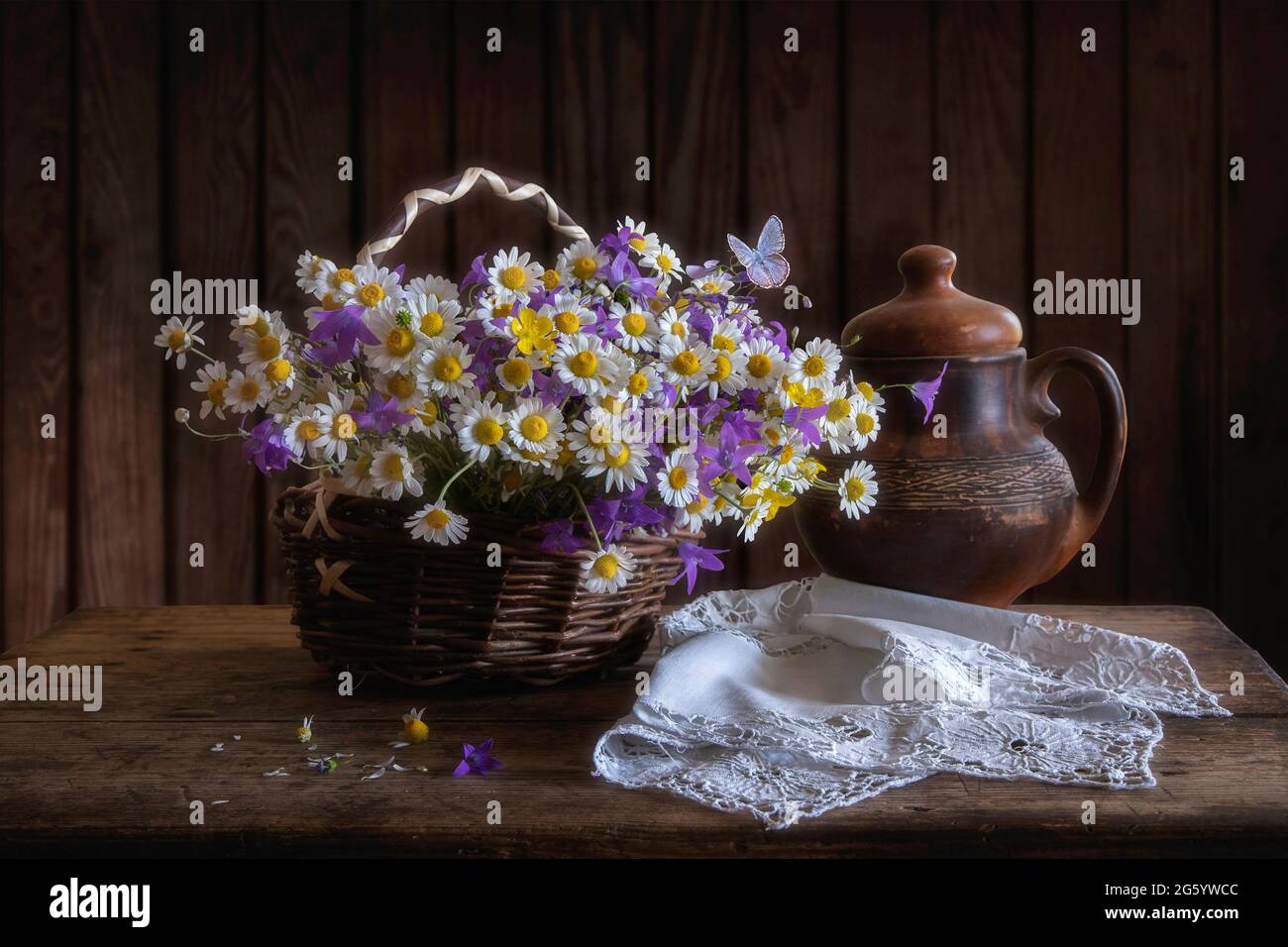 Rural still life with basket of wildflowers Stock Photo