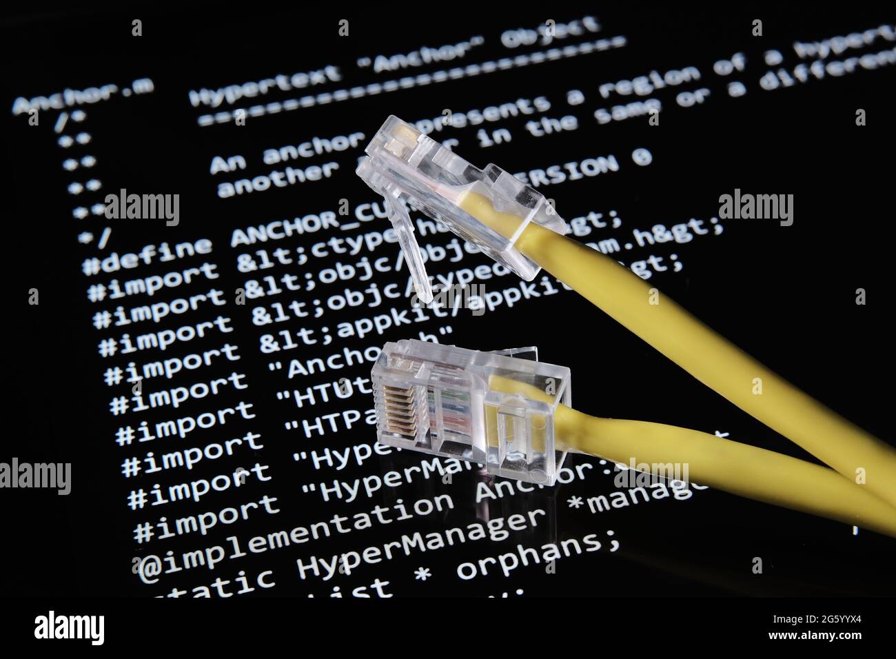 Internet cable and World Wide Web source code which was sold as NFT by Tim Berners Lee seen on the blurred background screen. Concept. Stafford, UK, J Stock Photo