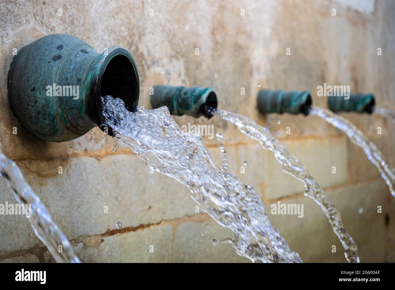 Water jets from a public fountain of Mijas Stock Photo