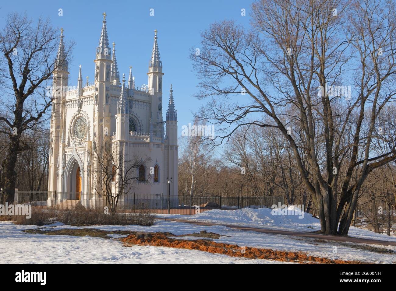 Peterhof, St. Petersburg, Russia, 19th March, 2019: Gothic chapel in Alexandria garden in a sunny spring day. The chapel was designed by Karl Friedrich Schinkel in Gothic Revival style in 1829 and consecrated in July 1834 Stock Photo