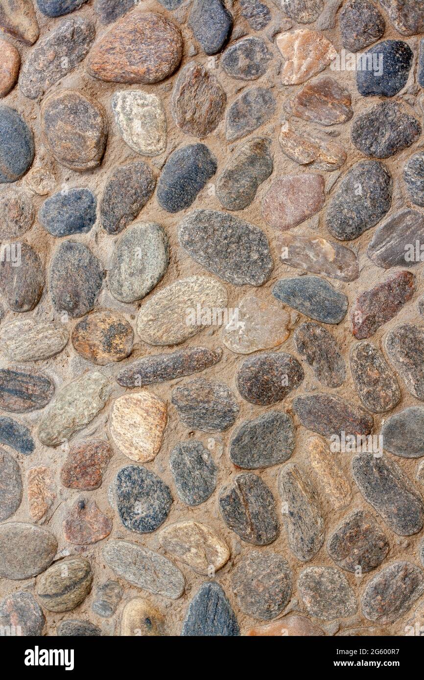 Texture background from granite paving stones. Cemented stones. Vertical image. Stock Photo