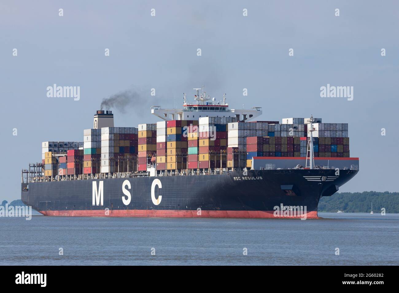 Stade, Germany - June 25, 2021: Container ship MSC REGULUS, built by Hyundai Heavy Industries, currently chartered to Mediterranean Shipping Company ( Stock Photo