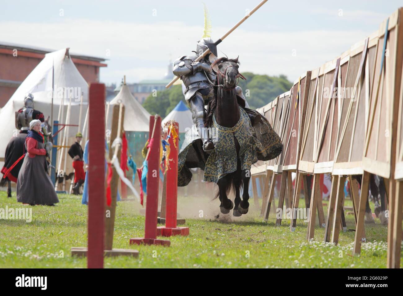 St. Petersburg, Russia - July 8, 2017: Armored knights on horses participating in the jousting tournament during the military history project Battle on Neva Stock Photo