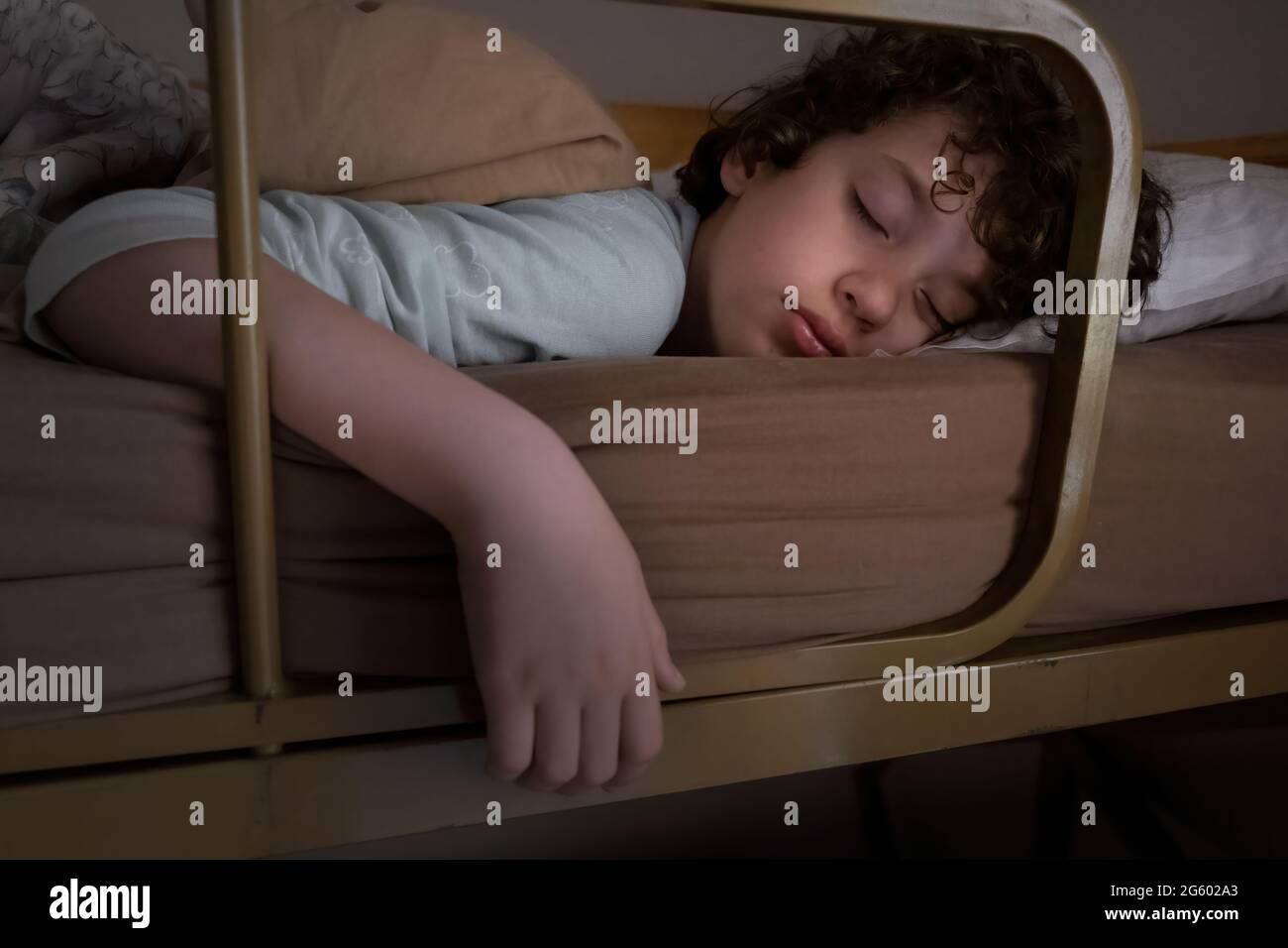 Little man sleeping on a bunk bed. Cute boy dreaming blissfully. Stock Photo