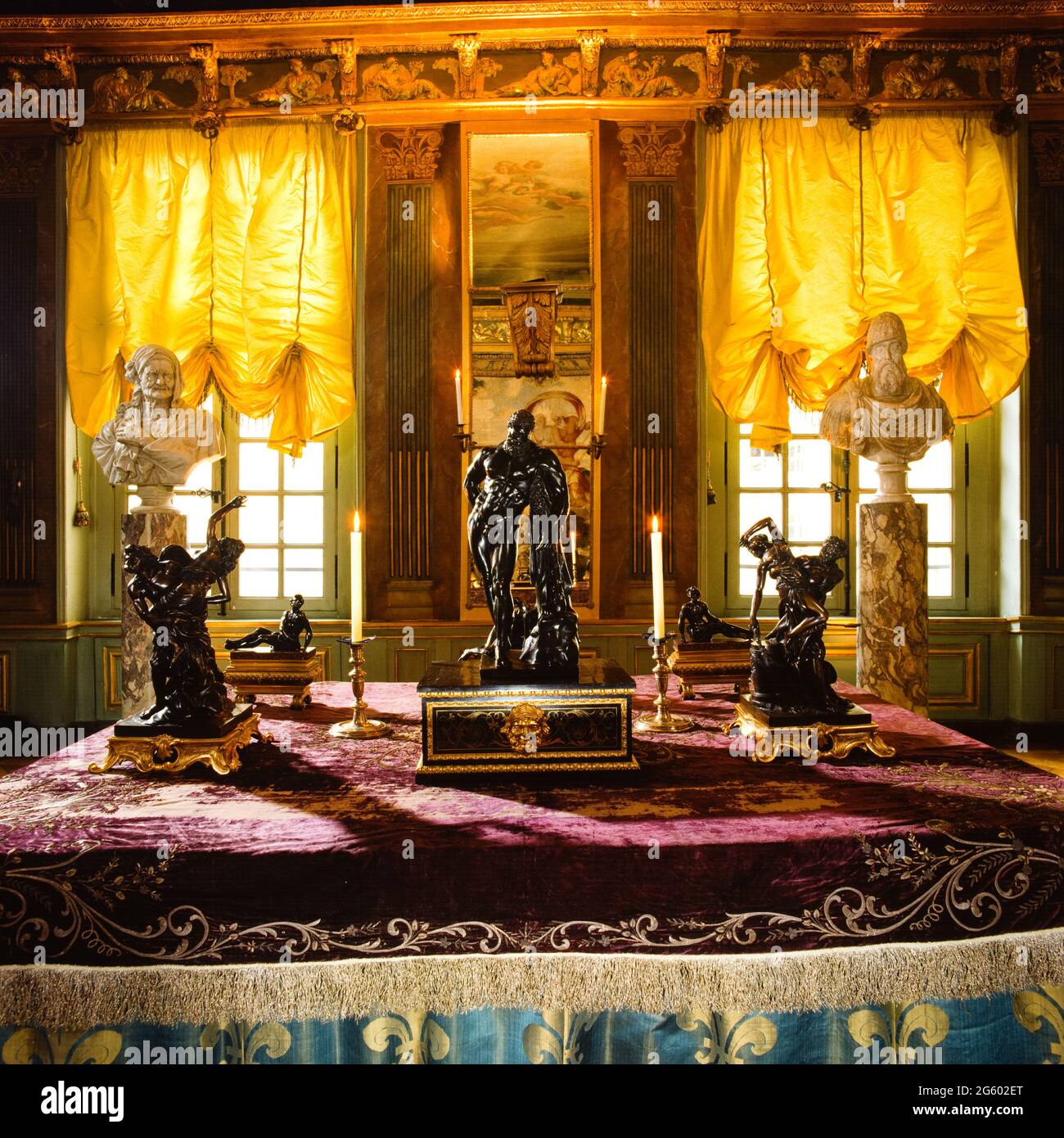 Sculpture on table with lit candles Stock Photo Alamy