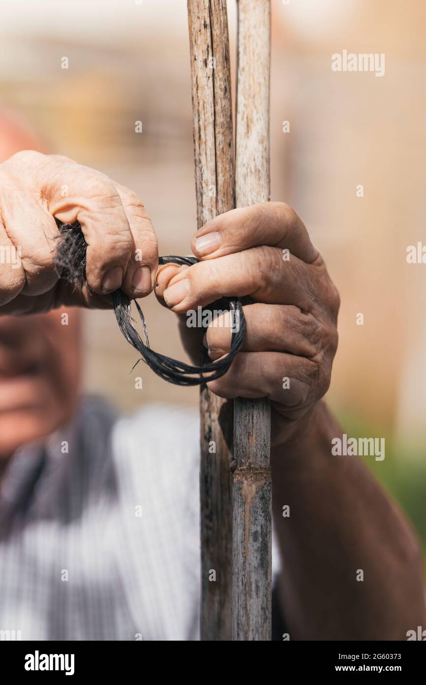 Older man's hands at work, selective focus on work being done Stock Photo