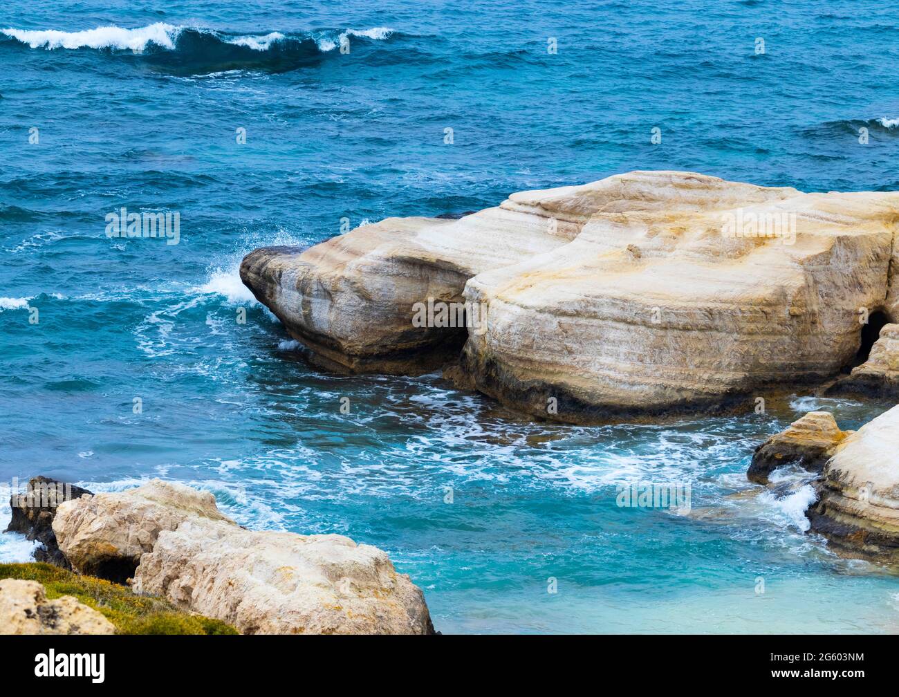 Ocean waves splash against beach with rocks background, Cliffs in the sea, Top aerial view of