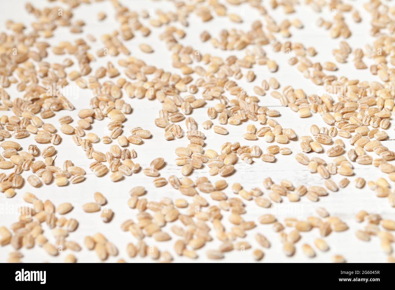 Close up of wheat seed on old white table. This file is cleaned and retouched. Stock Photo