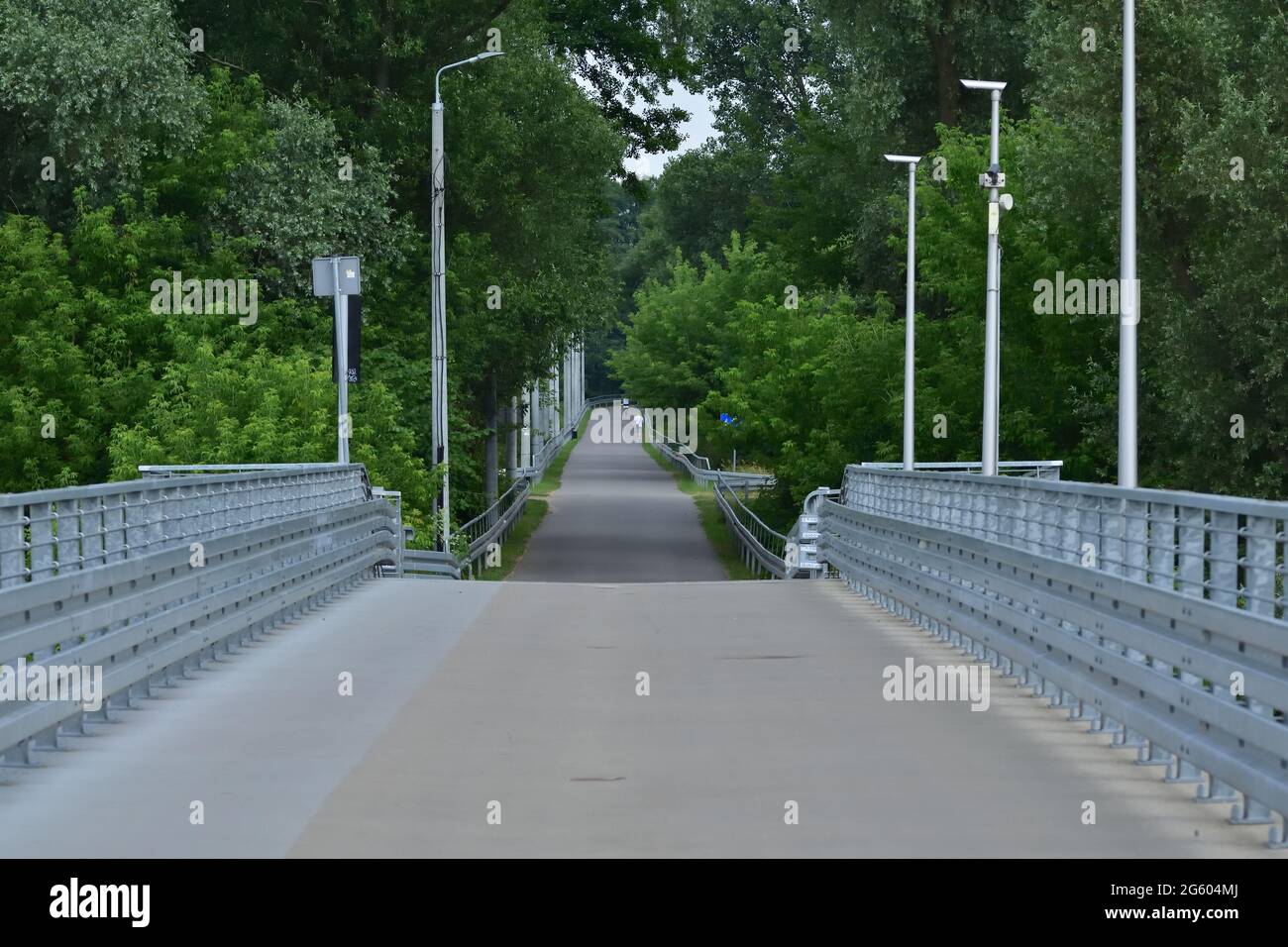 Bridge with railings and path for pedestrians and bicycles. Summer. Stock Photo