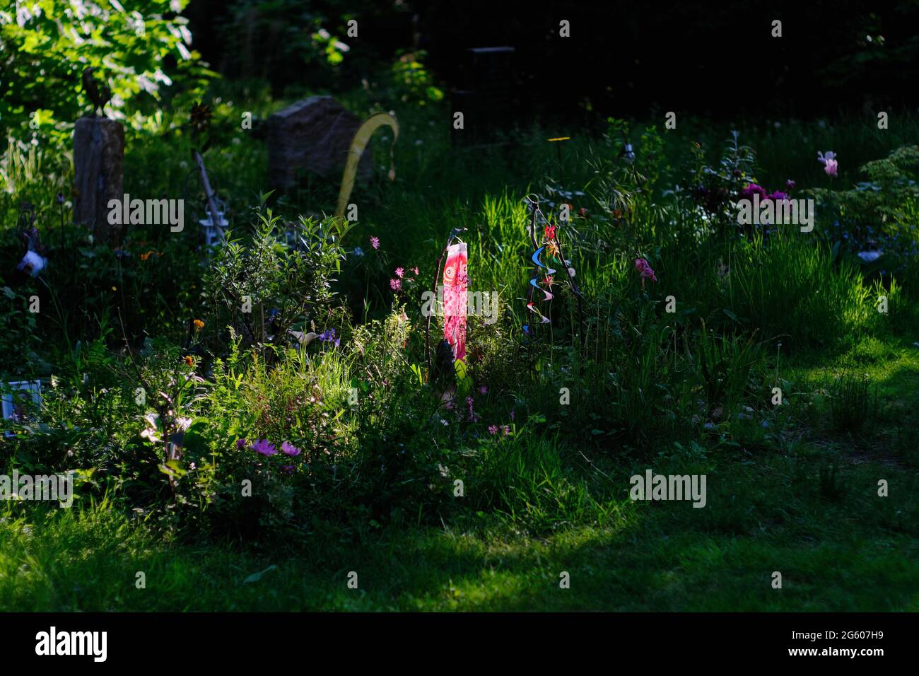 Berlin, Germany. 30th May, 2021. Grave decorations glow against the light on individually designed graves in the Luisenstädt cemetery. Credit: Stefan Jaitner/dpa/Alamy Live News Stock Photo