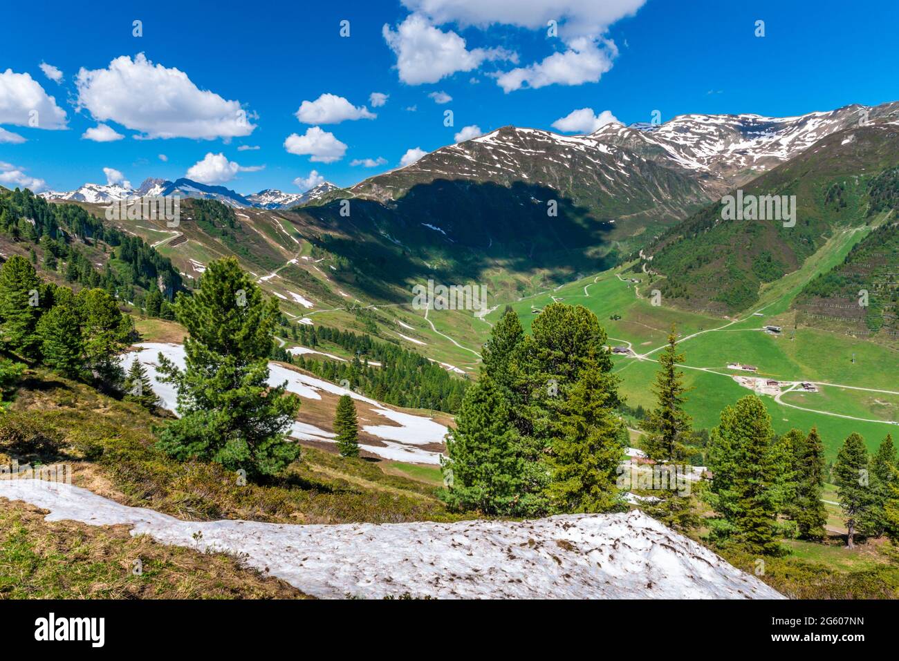landscape with trees, snow, grass, roads and blue sky in Austria, Zillertal Stock Photo