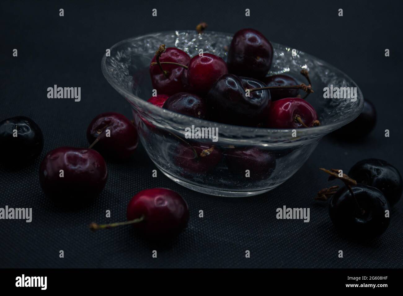 Cherries with water drops isolated in black backround. Ripe cherries. Sweet red cherry. top view. Rustic style. fruit wallpaper Stock Photo