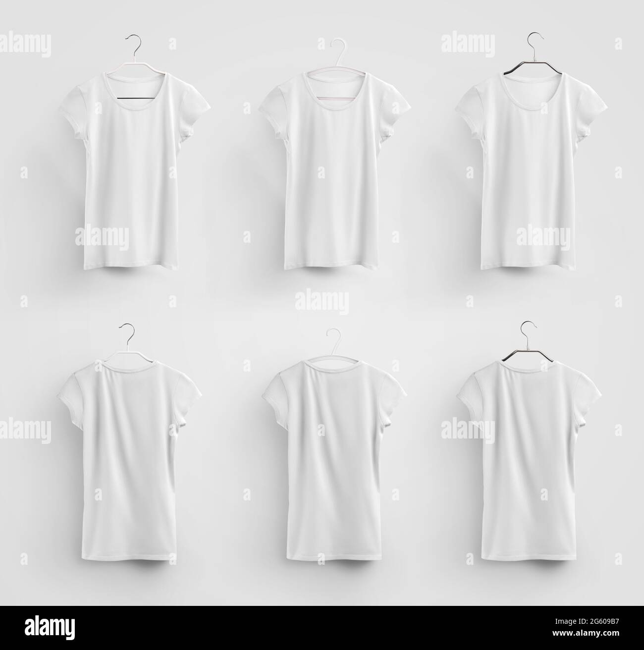Female white T-shirt template hanging on metal, plastic hangers, isolated on background. Mockup of trendy blank apparel, for design and pattern presen Stock Photo