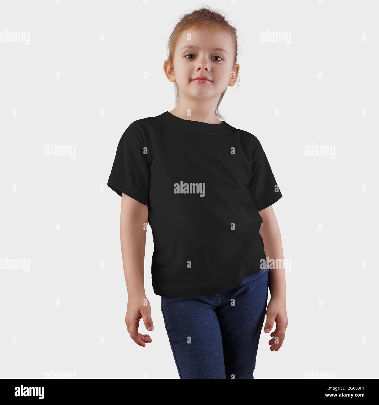 Presentation of mockup blank t-shirts on a pretty girl in blue jeans, children's clothing for design and advertising. Kidswear print template, texture Stock Photo