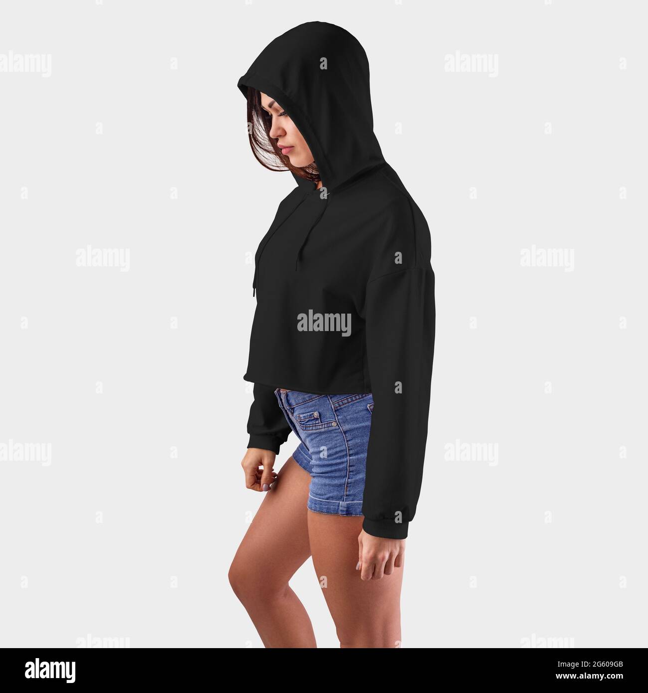 Template black hoodie for a girl in a hood with her head bowed, for presentation of design. Mockup of empty sweatshirt isolated on a white background. Stock Photo