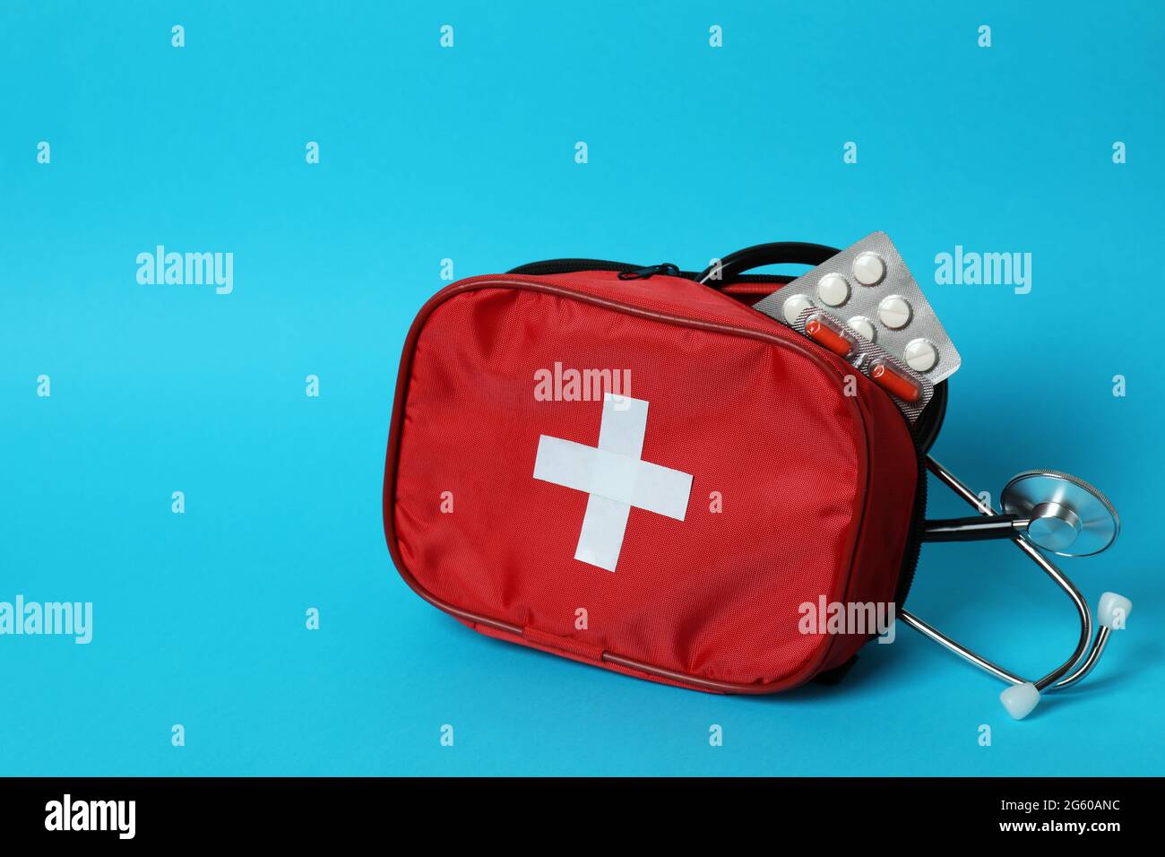 First aid medical kit on blue background Stock Photo - Alamy