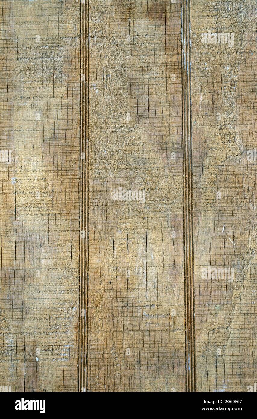This old wood surface has lost most of its color and is now a splotched, cracked and weathered board that offers lots of graphic art opportunities. Stock Photo