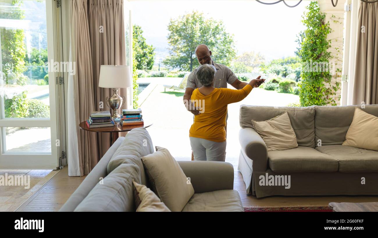 Senior african american couple dancing together in living room Stock ...