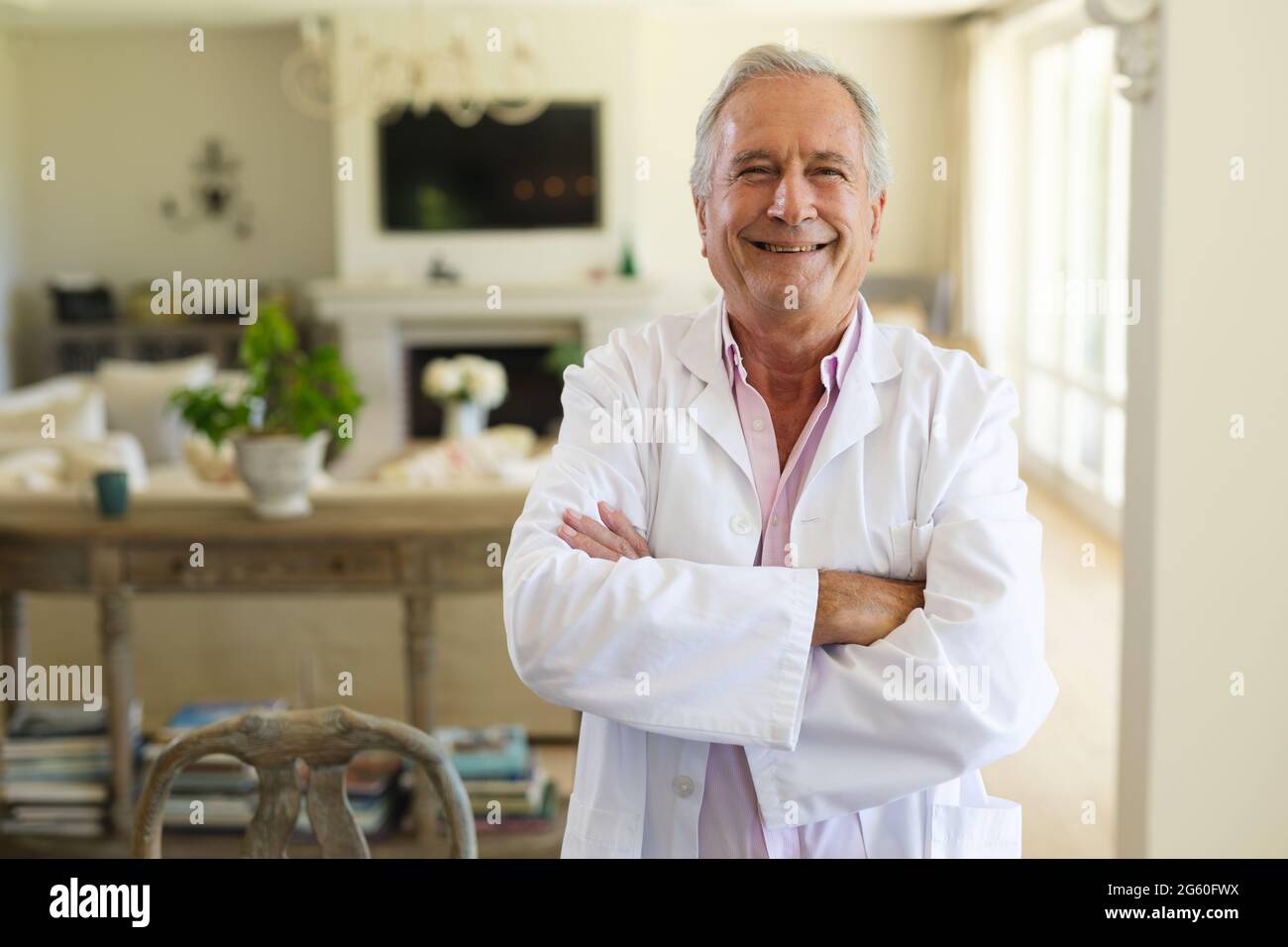 Portrait of senior caucasian male doctor looking at camera and smiling ...