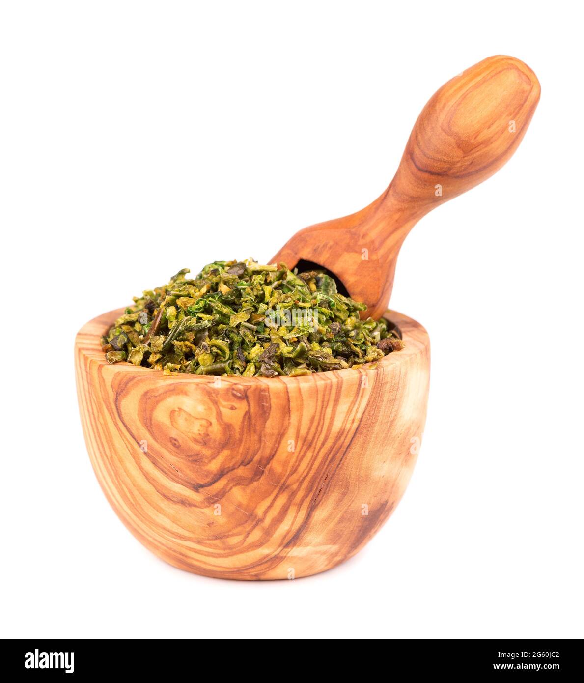 Dried green paprika flakes with seeds in olive bowl and scoop, isolated