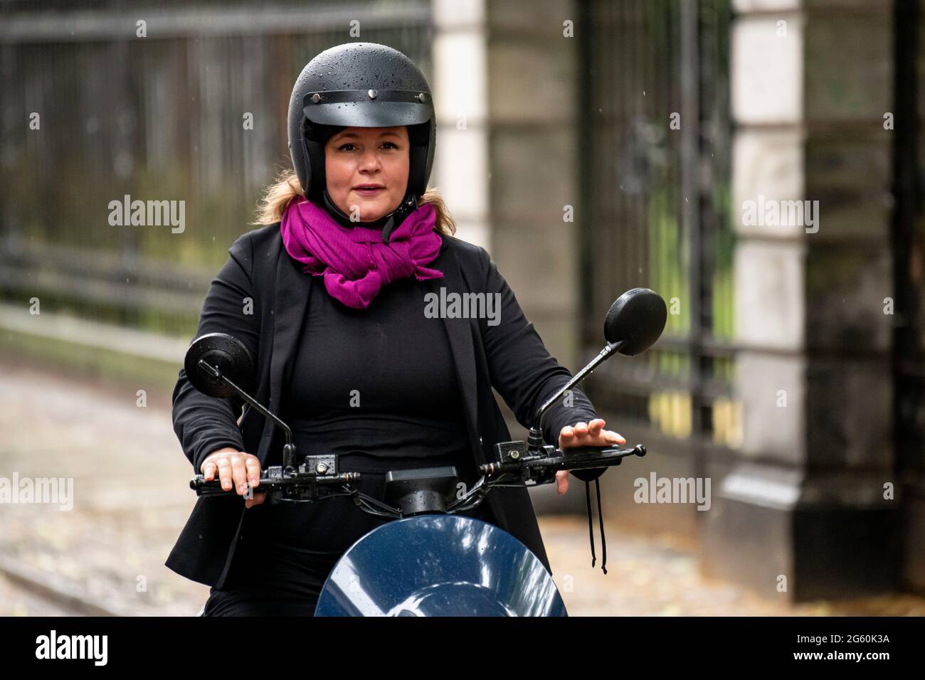 01 July 2021, Berlin: Antje Kapek, chairwoman of the Bündnis 90/Die Grünen  parliamentary group rides a unu scooter before an event celebrating the  three-year anniversary of the mobility concept in Berlin. On