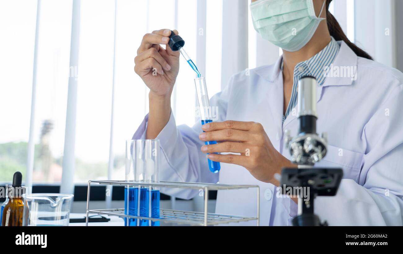 Scientist wear lab coat and protective wear are working with research