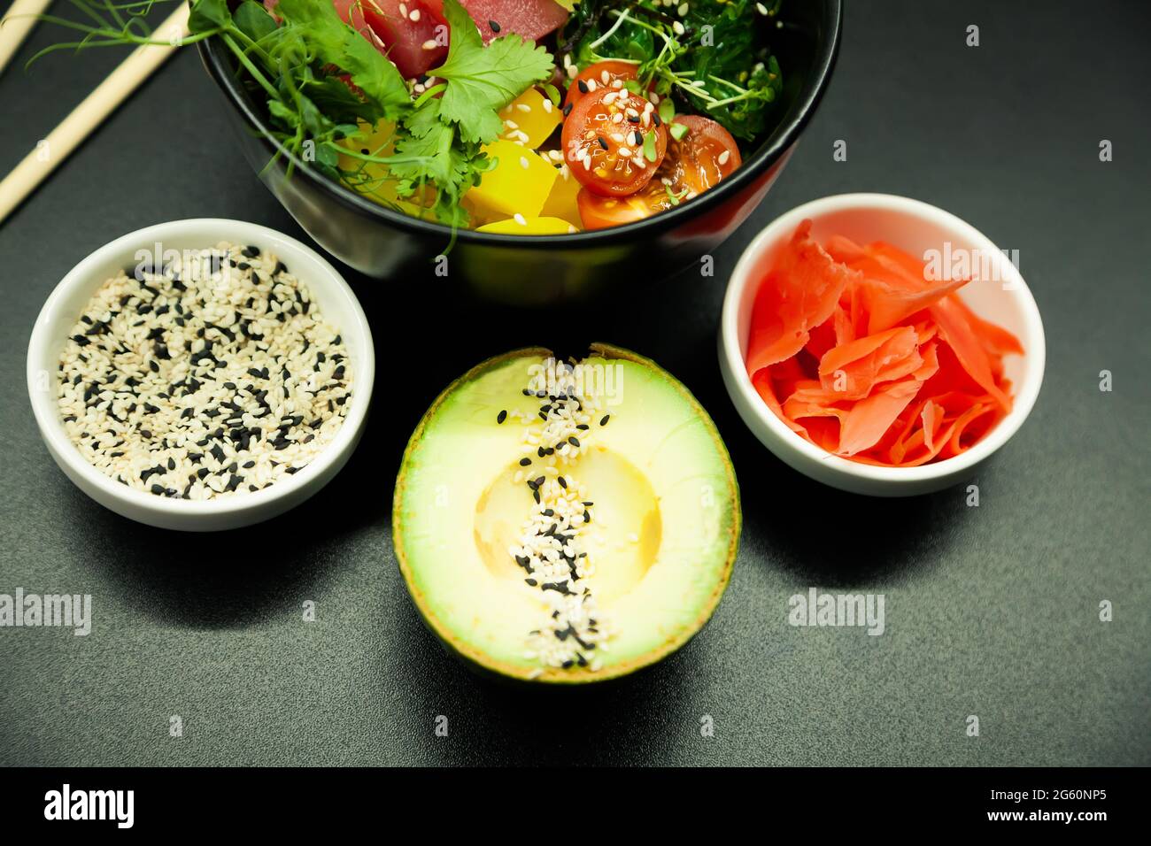 Poke salad with tuna in a bowl. Ingredients fresh tuna, cherry tomatoes