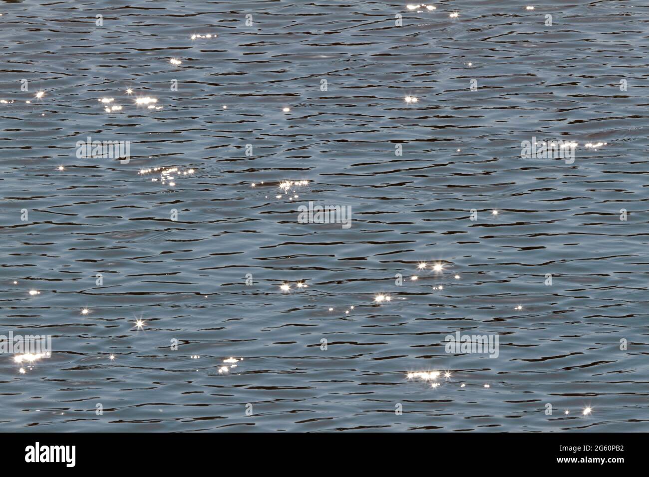 Sunlight glistens on the rippling water. Stock Photo