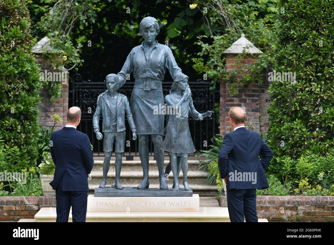 The Duke of Cambridge (left) and Duke of Sussex look at a statue they commissioned of their mother Diana, Princess of Wales, in the Sunken Garden at Kensington Palace, London, on what would have been her 60th birthday. Picture date: Thursday July 1, 2021. Stock Photo