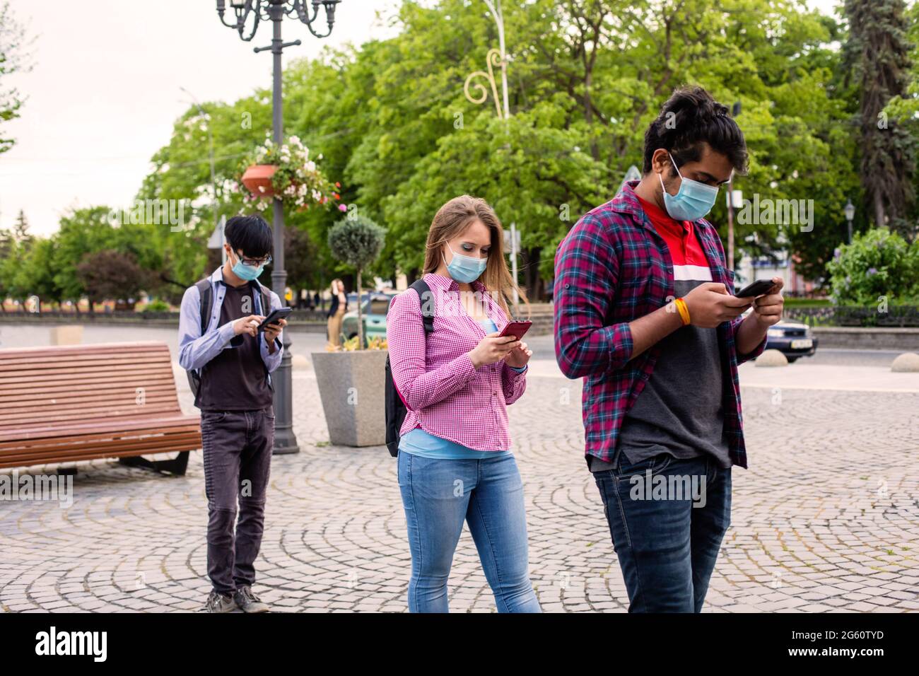 People in masks stand queue keeping social distance Stock Photo - Alamy