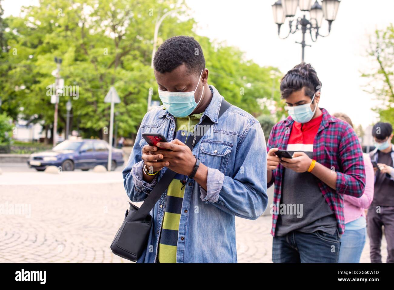People in masks stand queue keeping social distance Stock Photo - Alamy