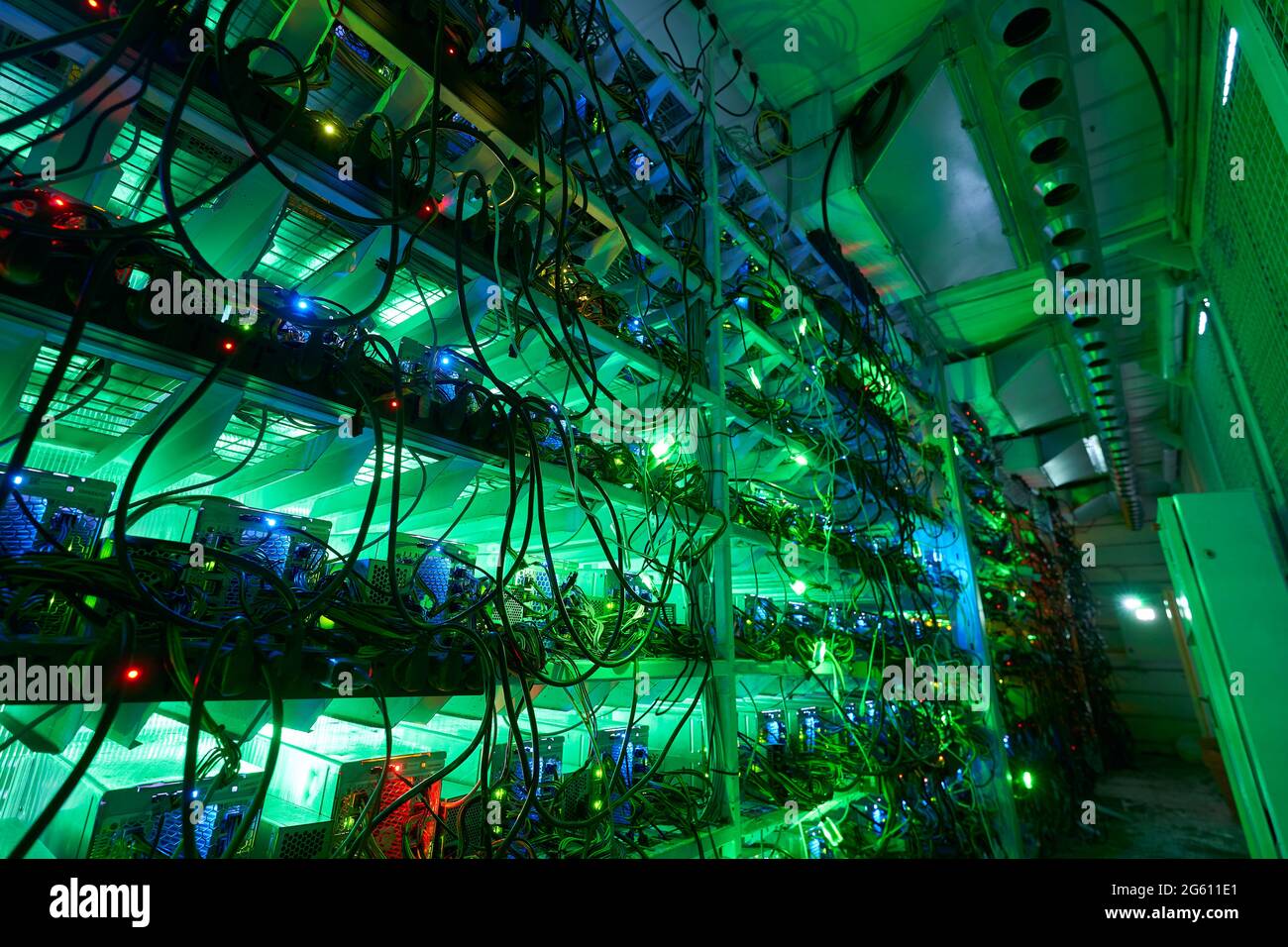 Bitcoin miners in large farm. ASIC mining equipment on stand racks mine ...
