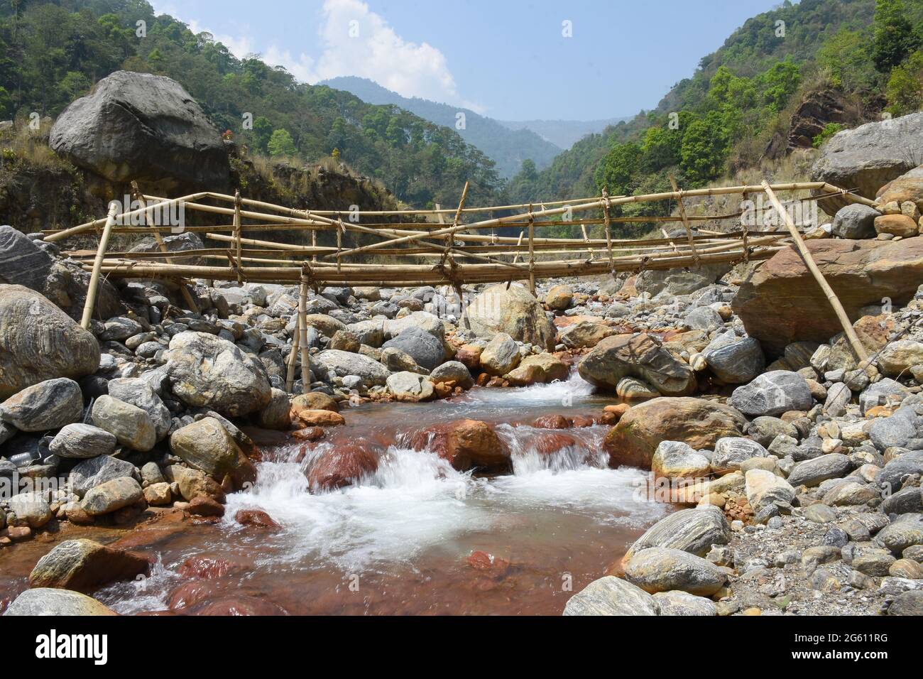 Villagers makeshift Bamboo bridge over high current himalyan river ,the only link in remote village ,Todey , Kalimpong . Stock Photo