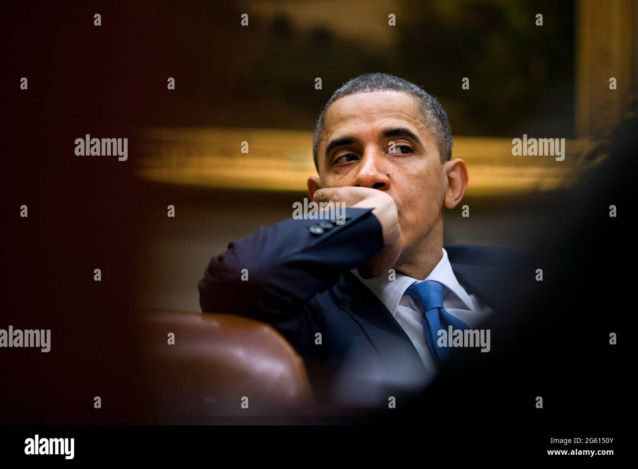 WASHINGTON DC, USA - 22 December 2010 - US President Barack Obama listens during a meeting with his staff in the Roosevelt Room of the White House in Stock Photo