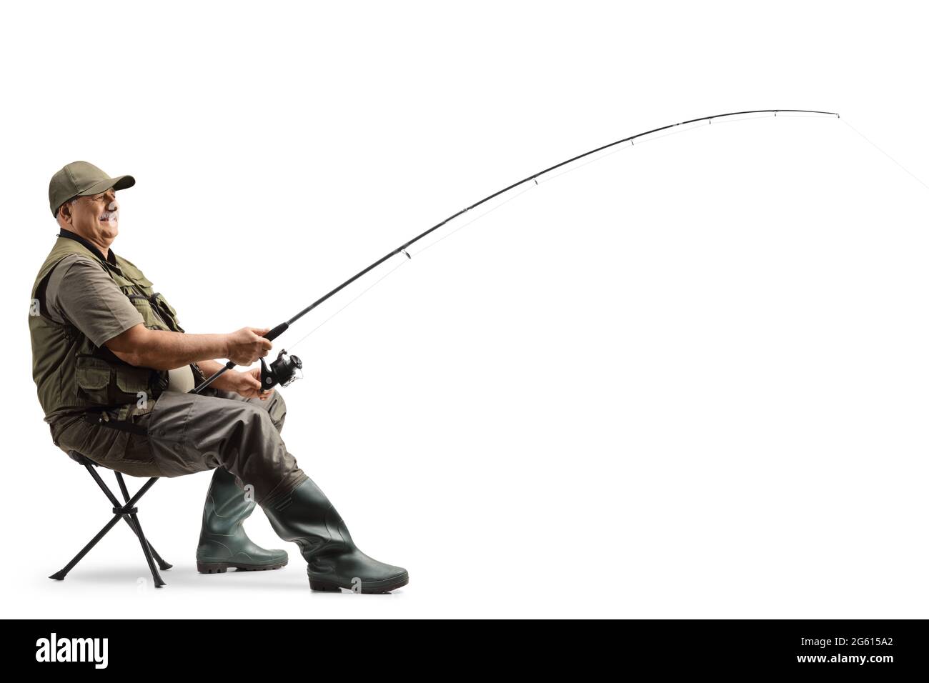 Profile shot of a mature fisherman sitting on a chair with a