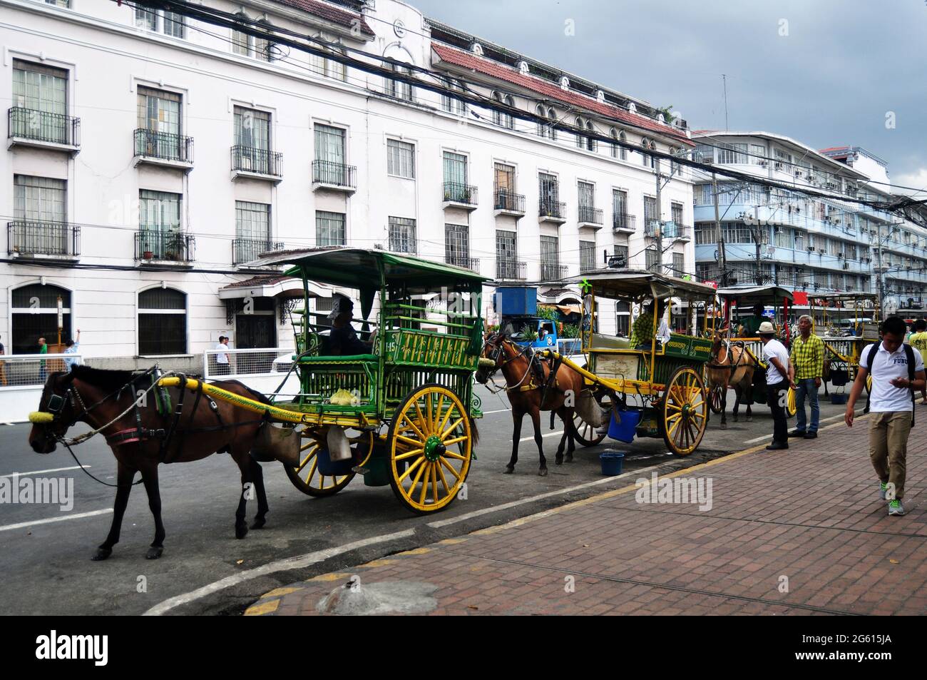 Filipino sit ride horse drawn carriages and waiting for Philippine people and foreign travelers use service travel visit tour Intramuros Square at May Stock Photo